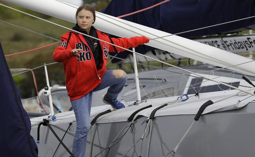 Greta Thunberg climbs onto the boat Malizia as she prepares to set off for the U.S. from Plymouth, England. The 16-year-old activist will attend a United Nations climate summit.