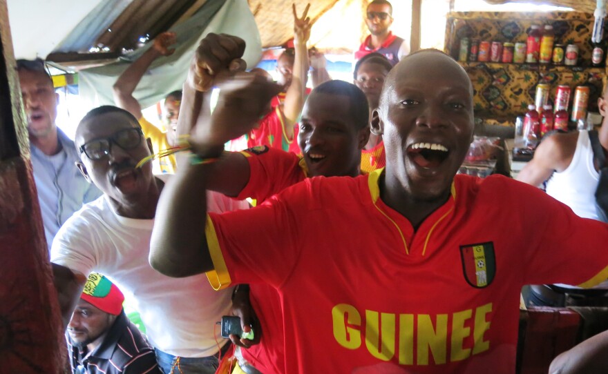 Fans in a makeshift sports bar in Conakry celebrate when Guinea scores a goal.