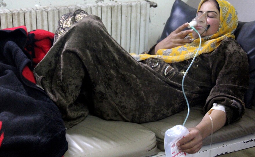 A woman, affected by what activists say was a chlorine gas attack, breathes through an oxygen mask inside a field hospital in Kfar Zeita village in the central province of Hama on April 12. Activists, doctors and political opposition members say there have been at least seven gas attacks in the past six weeks.