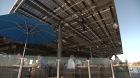 Patrons eat at the new restaurant Coasterra on San Diego Bay under a canopy that is covered with solar energy collector cells,  Jan. 25, 2016. 