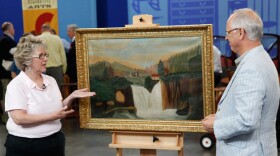 Appraiser Ken Farmer examines a painting with a guest on "Junk In The Trunk 2."