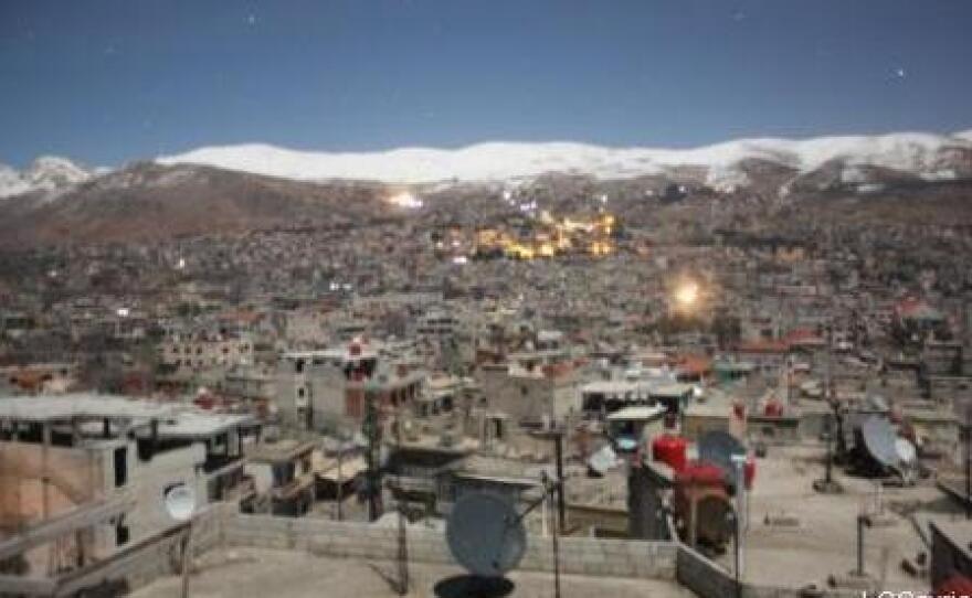 An image from the Local Coordinating Committees of Syria website shows the mountain town of Zabadani in the distance, during a barrage on Feb. 9.