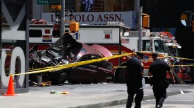 A smashed car sits on the corner of Broadway and 45th Street in New York's Times Square after ploughing through a crowd of pedestrians at lunchtime on Thursday, May 18, 2017