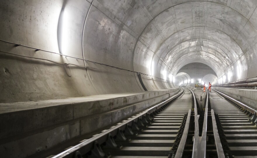 Train tracks lead toward an access tunnel inside the east section of the Gotthard Base Tunnel in Faido, Switzerland, in 2014. The tunnel had its opening ceremony on Wednesday.