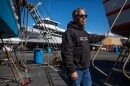 Jared Davis stands beside his charter fishing boat, Salty Lady, as it sits in dry dock in Richmond on March 8, 2023.