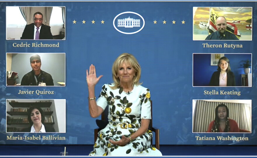 An image from video provided by the White House shows first lady Jill Biden meeting with her virtual guests ahead of President Biden's joint address on Wednesday. Many Democratic lawmakers are also naming guests of honor, who will be watching the speech remotely.