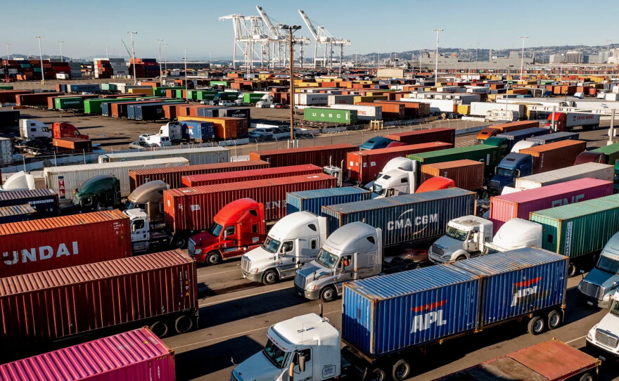 Trucks line up to enter a Port of Oakland shipping terminal in Oakland on Nov. 10, 2021.