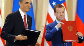 President Obama and his Russian counterpart, Dmitry Medvedev, hold up their signed copies of the nations' latest strategic arms treaty, called New START, on Thursday at Prague Castle in the Czech capital.