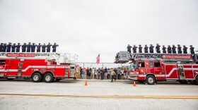 San Diego Fire-Rescue Department and La Mesa Fire Department personnel salute as the procession for slain San Diego police Officer Jonathan De Guzman passes through eastbound Interstate 8, Aug. 5, 2016. 