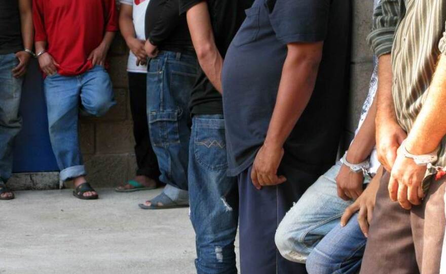 Suspected members of the Mara Salvatrucha gang under arrest at a San Salvador police station. The 24 suspects were arrested in a police raid. Police officials say they're accused of major crimes including homicide, rape, extortion and drug possession.