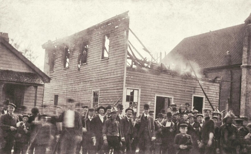 Mob outside burned offices of The Daily Record. November 1898.