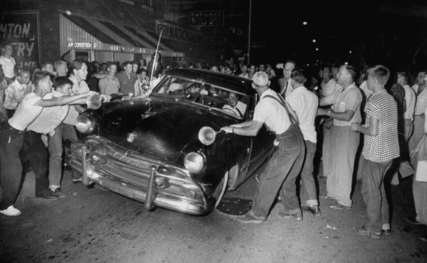 A crowd attacking cars driven by African Americans to protest integration in the schools. (undated photo)