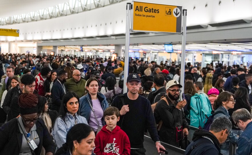 People wait in long TSA security lines at John F. Kennedy International Airport (JFK) in the Queens borough of New York, Monday, March 23, 2026.