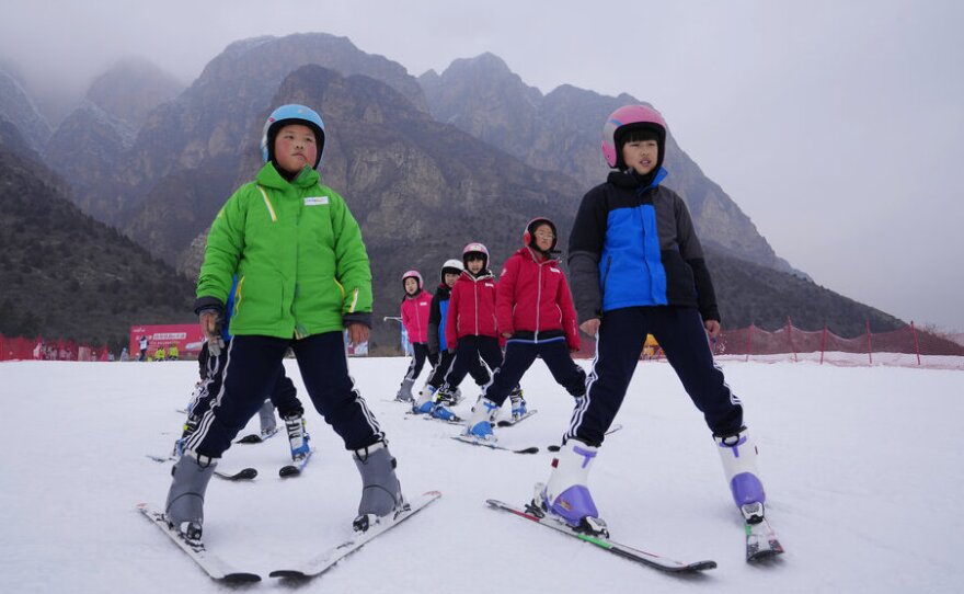 School children learning to ski take to the slope at the Vanke Shijinglong Ski Resort in Yanqing on the outskirts of Beijing, China, Thursday, Dec. 23, 2021.