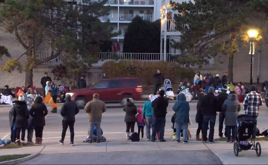 A red vehicle is seen speeding through a parade route in Waukesha, Wis., on Saturday evening, in a livestreamed video on the City of Waukesha's Facebook page.