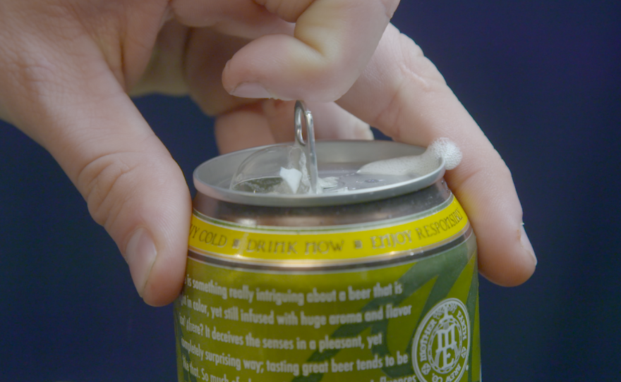 A person cracks open a beer from Mother Earth Brew Company, Feb. 29, 2016.