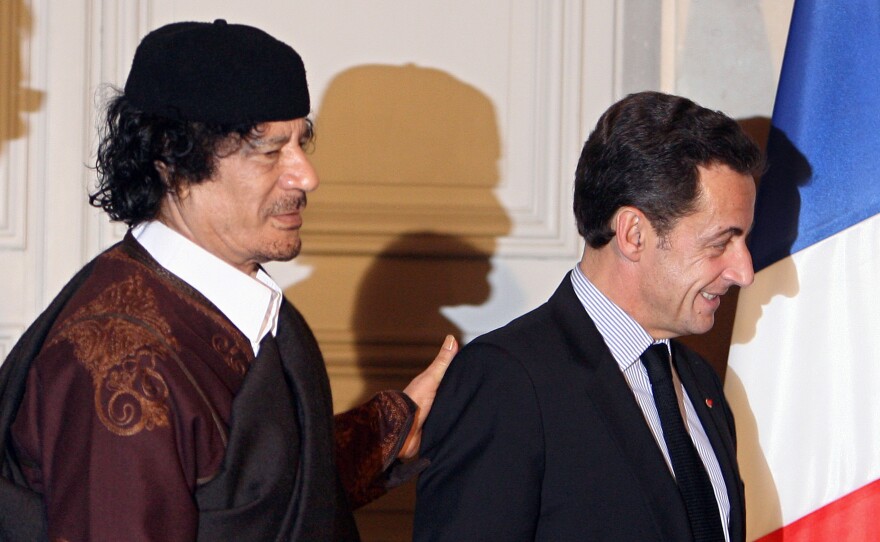 French President Nicolas Sarkozy (right) and Libyan leader Moammar Gadhafi leave the Elysee Palace after the signature of 10 billion euros of trade contracts between the two countries, in December 2007 in Paris.