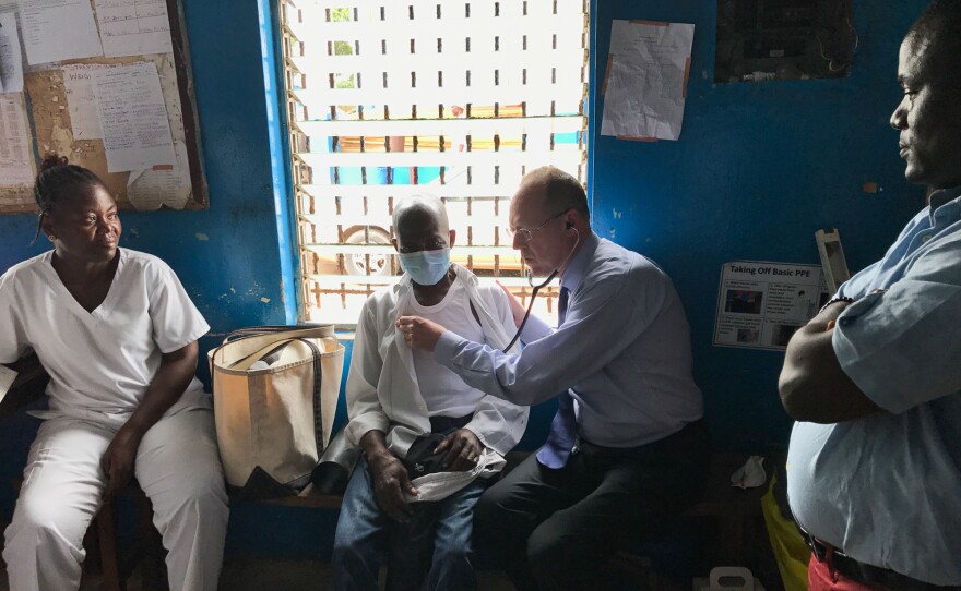 Dr. Paul Farmer examines a tuberculosis patient in Monrovia, Liberia.