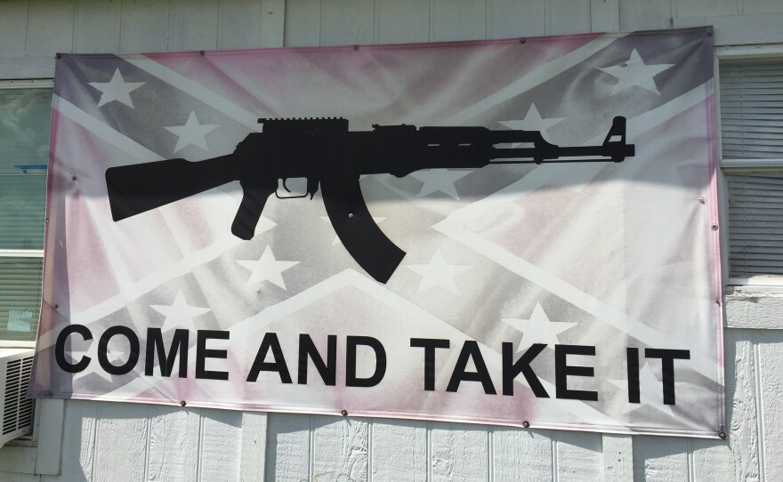 A "Come and Take It" flag is superimposed on a Confederate battle flag on a building off U.S. Highway 290 east of Austin. People are adapting the slogan to various causes.