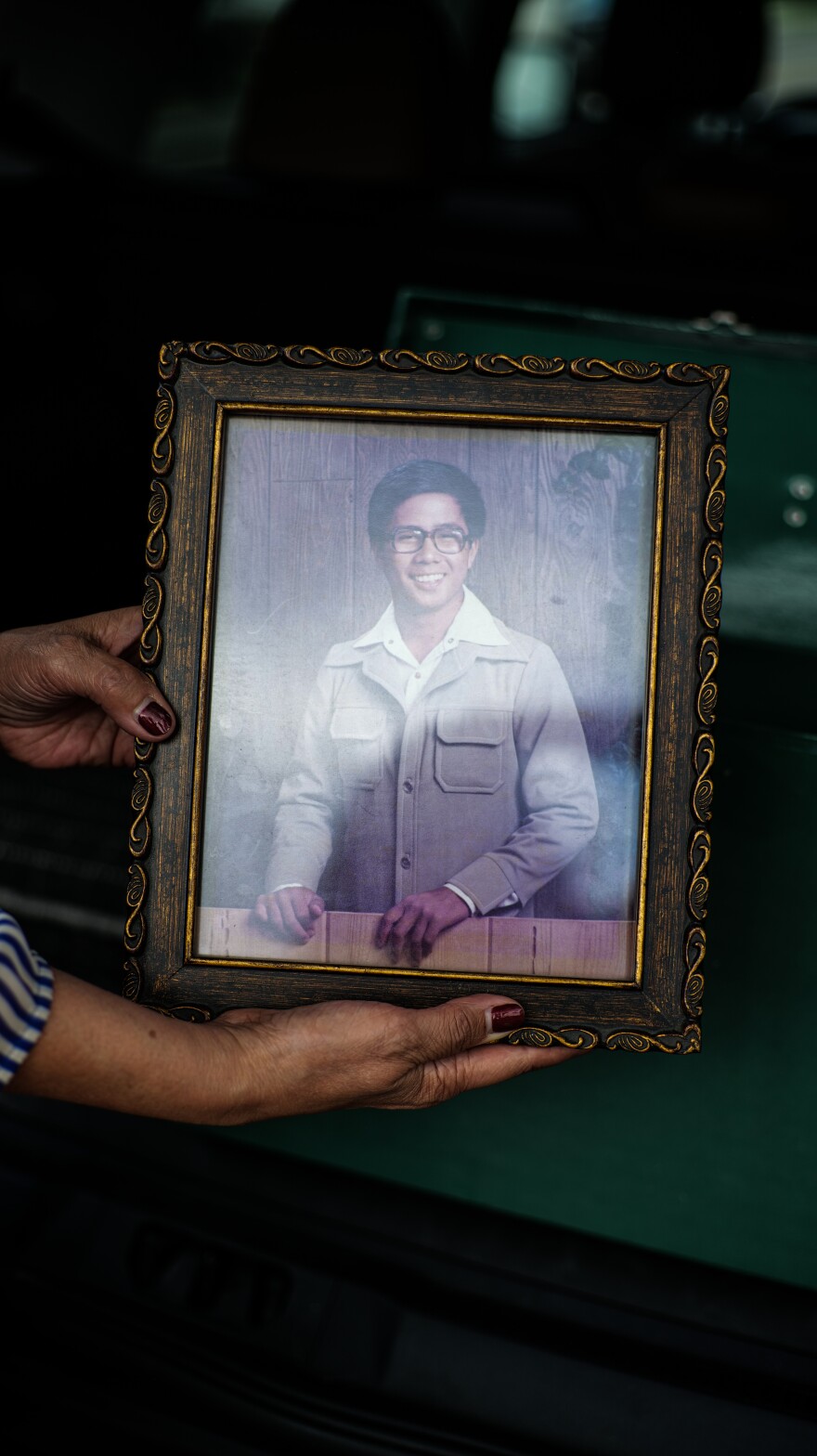 Michael Sulit's graduation picture is shown being held by his sister Myra Sulit Pelowski on Sept. 19, 2023.