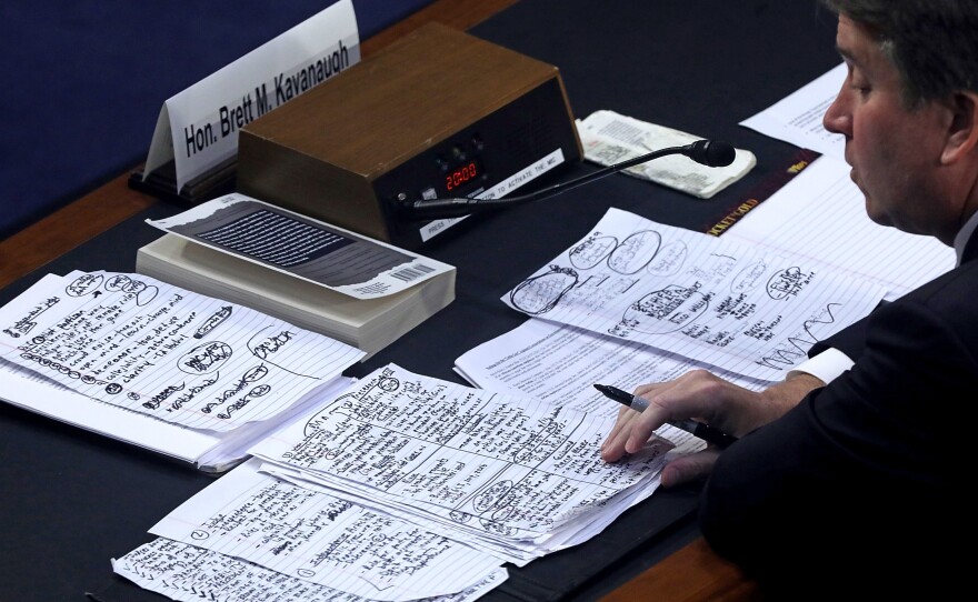 Kavanaugh looks over his notes while testifying on Thursday.