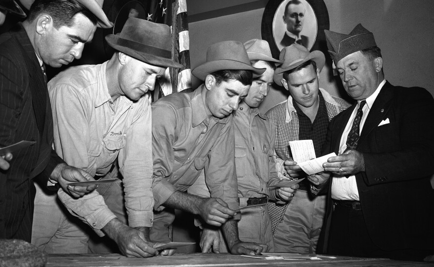 A group registers for military selective service at the Dallas state fair grounds in October 1940. The Supreme Court said Monday it would not hear a case challenging the rule that only men need to register for the draft.