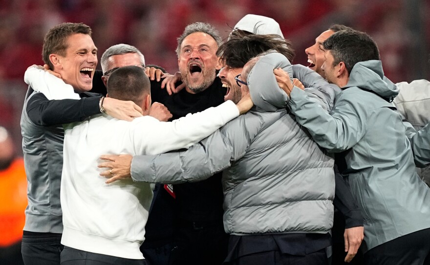 PSG's head coach Luis Enrique, center, celebrates with the other members of the team after the Champions League semifinal second leg soccer match between Bayern Munich and Paris Saint Germain in Munich, Germany, Wednesday, May 6, 2026.