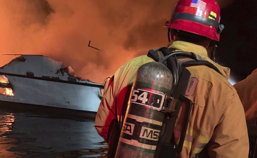 In this photo provided by the Ventura County  firefighters respond to a boat fire off the coast of southern California, Monday, Sept. 2, 2019.