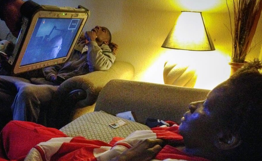 Susan Carrington, 56, has a video chat with a doctor from her apartment. The doctor reviewed her symptoms and arranged a clinic appointment for the next morning instead of an immediate ambulance ride to the emergency room.