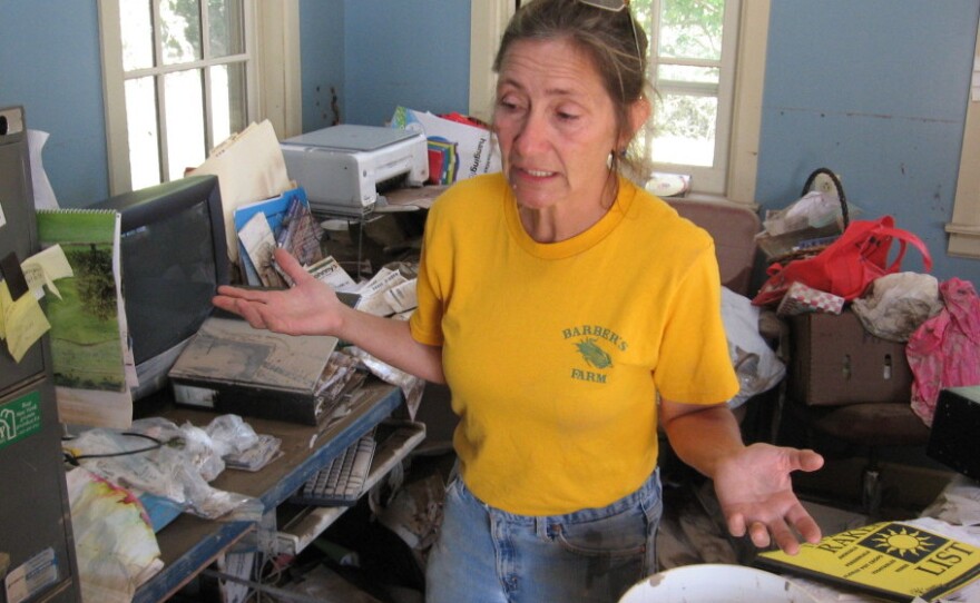 Cindy Barber, in the office of her flooded house, decides what to salvage and what to toss.