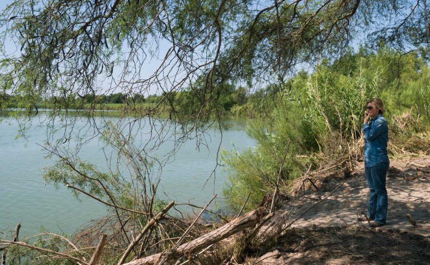 Marianna Trevino Wright, executive director of the National Butterfly Center, stands at the edge of the center's property where it meets the Rio Grande.