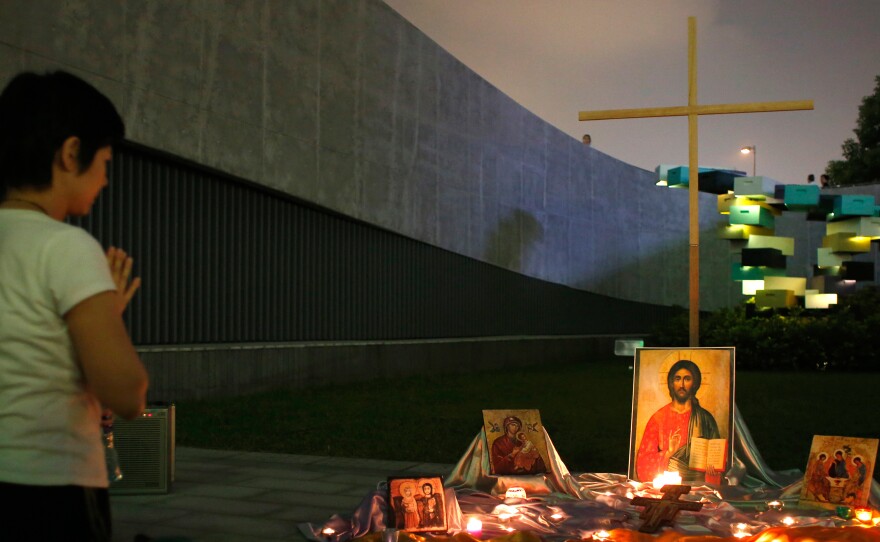 A student prays in front of a temporary altar during a rally outside government headquarters in Hong Kong on Sept. 24, 2014.