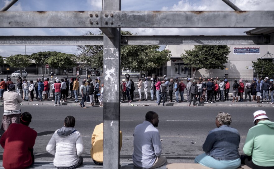 Shoppers line up outside a supermarket in the township of Khayelitsha. On day nine of the lockdown, there was a two-hour wait to get into the store.