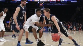 George Washington's Alex Mitola (1) drives past San Diego State's Jeremy Hemsley (42) as Patricio Garino (13) sets a pick during the second half of an NCAA college basketball game in the semifinals of the NIT in New York, March 29, 2016. George Washington won 65-46. 
