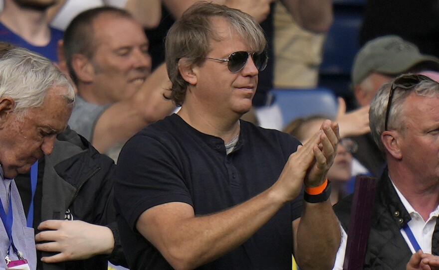 American businessman Todd Boehly, centre, applauds as he attends the English Premier League soccer match between Chelsea and Watford at Stamford Bridge stadium in London, Sunday, May 22, 2022.