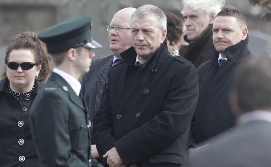 Jackie McDonald (center), is shown here at a funeral in 2011. He once ran the Ulster Defence Association, the biggest Protestant paramilitary group in Northern Ireland. Now, he works for a group that seeks peace. But he says many young people don't seem to want resolution: "They've heard stories about their grandfather or their uncle. So these young people think they've missed out."