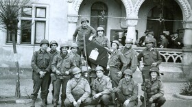 Group around Jewish chaplain's flag, Written on back: "end of war for 104th Inf. 1945."
