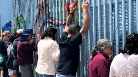 In this photo taken May 5, 2019, Border Church is underway, and people in Tijuana use this spot at the border wall to meet family and friends separated by immigration status on the U.S. side. 