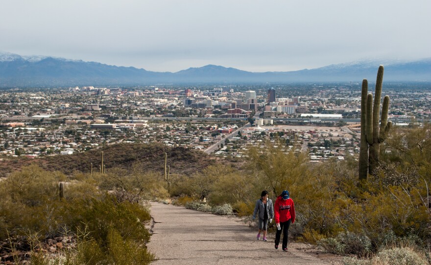 <strong></strong>Hikers climb past saguaro cacti on Tumamoc Hill, just west of downtown Tucson. The popular hiking path is trafficked by a far more diverse group of people than neighboring Saguaro National Park.