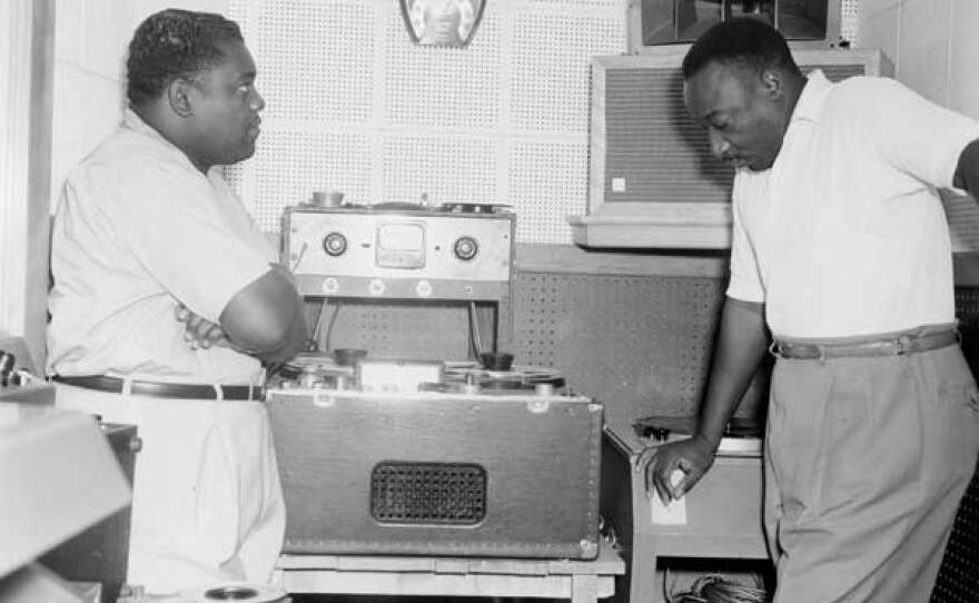 Fats Domino and Dave Bartholomew, producer/songwriter/bandleader and longtime collaborator, who co-wrote and produced most of Fats’ hits, at J&M Studio, 1956.