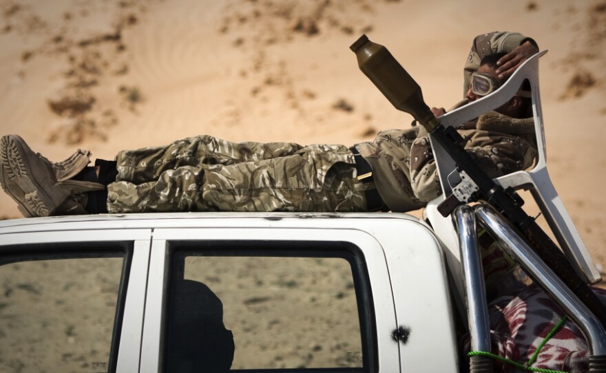 A Libyan rebel rests at a checkpoint on a front line near Zwitina, the outskirts of the city of Ajdabiya, south of Benghazi, in eastern Libya on March 24.