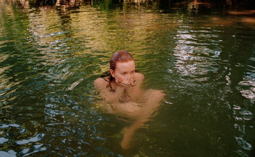 Madison Greer taking a dip in a creek earlier this summer just outside Franklin, Tenn., where she grew up.