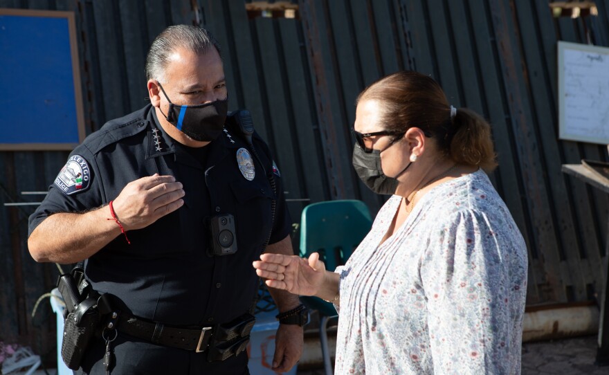 Calexico Police Chief Gonzalo Gerardo speaks with Councilmember Gloria Romo before clearing a farmworker encampment, April 7, 2020. Romo was advocating for the postponement of the police action.