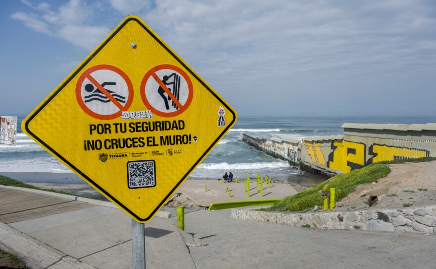 A signs telling people not to climb over or swim around the border wall is shown on March 14, 2024. The city of Tijuana installed the signs in response to injuries and fatalities.