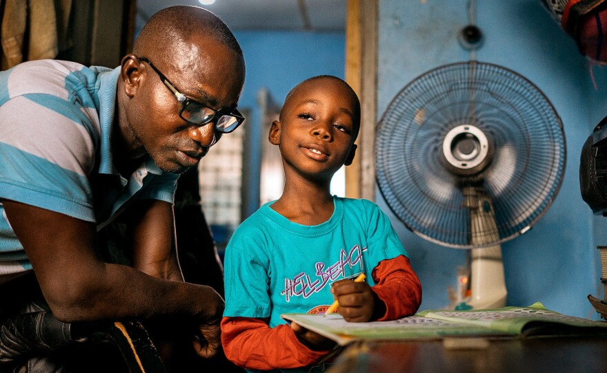 It's their nightly ritual: Herman Agbavor sits down with his 5-year-old son, Herbert, to go over his homework.
