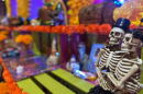 Two embracing skeletons sit on an altar at the Sherman Heights Community Center on Oct. 15, 2025