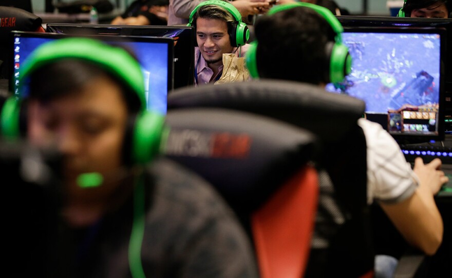 an esport (electronic sport) player smiles during the qualifying rounds for the first Philippine esport team in metropolitan Manila, Philippines, Thursday, Aug. 29, 2019.