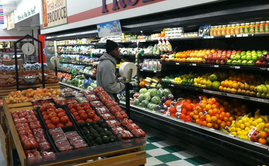 A customer in the produce section at Metro Foodland, one of the Detroit grocery stores participating in a healthy food incentive program for people with SNAP benefits. The store will add a section of specially marked local produce as part of the program.