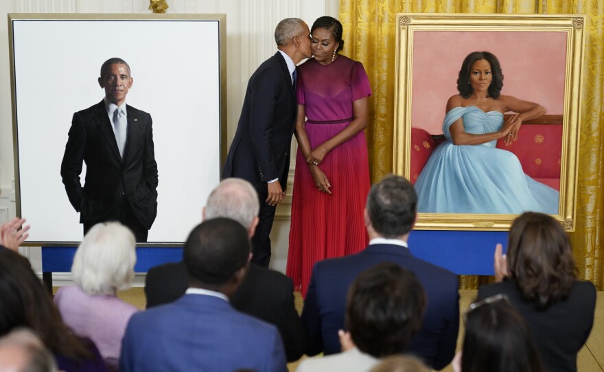 Former President Barack Obama kisses his wife former first lady Michelle Obama after they unveiled their official White House portraits during a ceremony for the unveiling in the East Room of the White House on Wednesday in Washington.