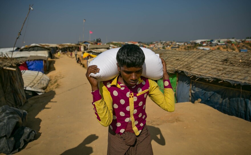 A Rohingya refugee carries a bag of food in the Hakimpara camp in Bangladesh.